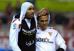 Sevilla's Frederic Kanoute celebrates scoring a goal by unveiling a t-shirt displaying his support for Palastine